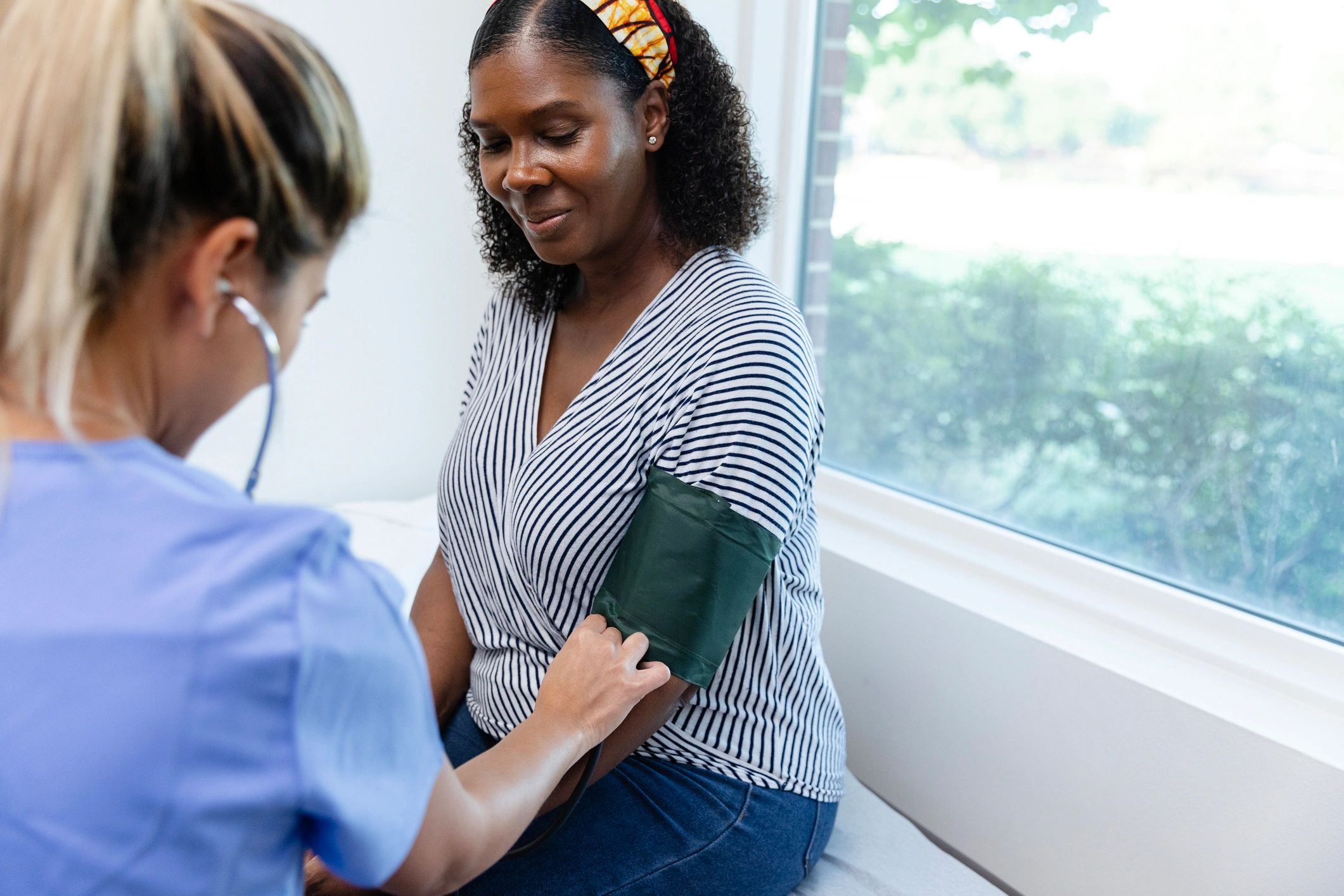 Nurse checking a patient's blood pressure