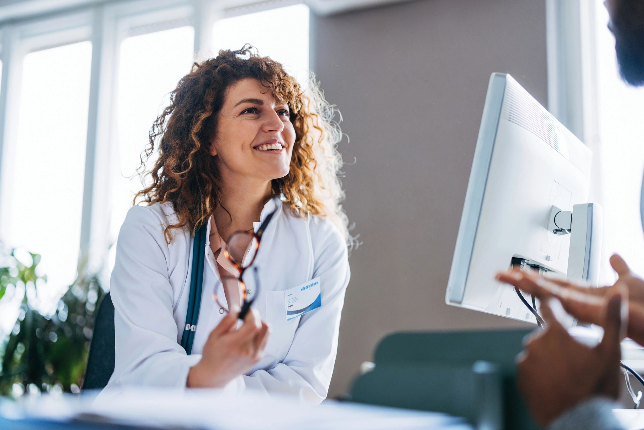 Doctor consulting with a patient in a bright clinic office